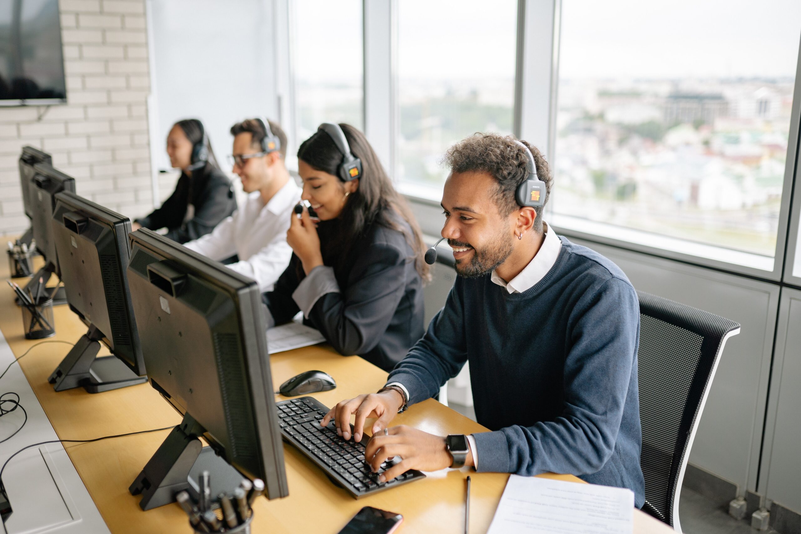 call-center-employee-diversity A small group of diverse employees working in a call center.